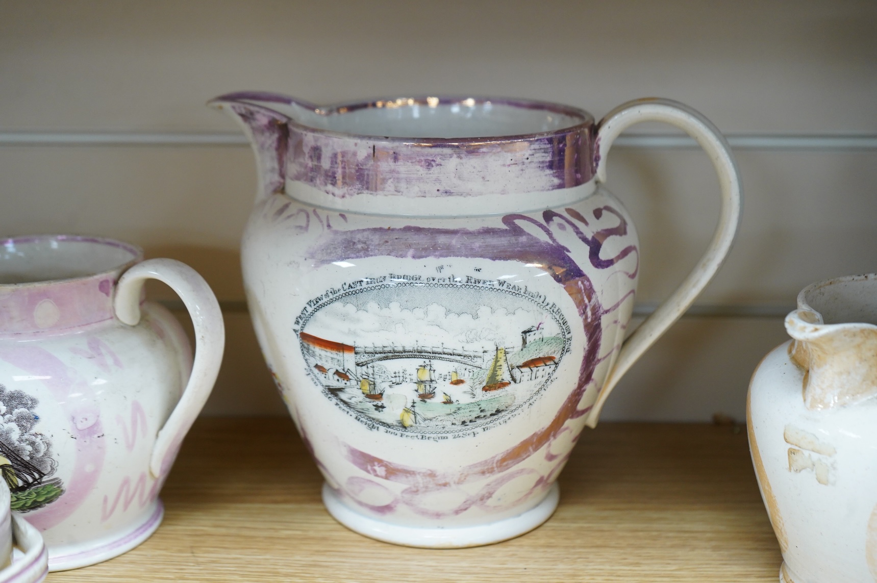 Six early 19th century commemorative jugs and bowls, three with transfer printed scenes of the cast iron bridge over the River Wear commemorating the opening in 1796, together with three others with naval themes, largest
